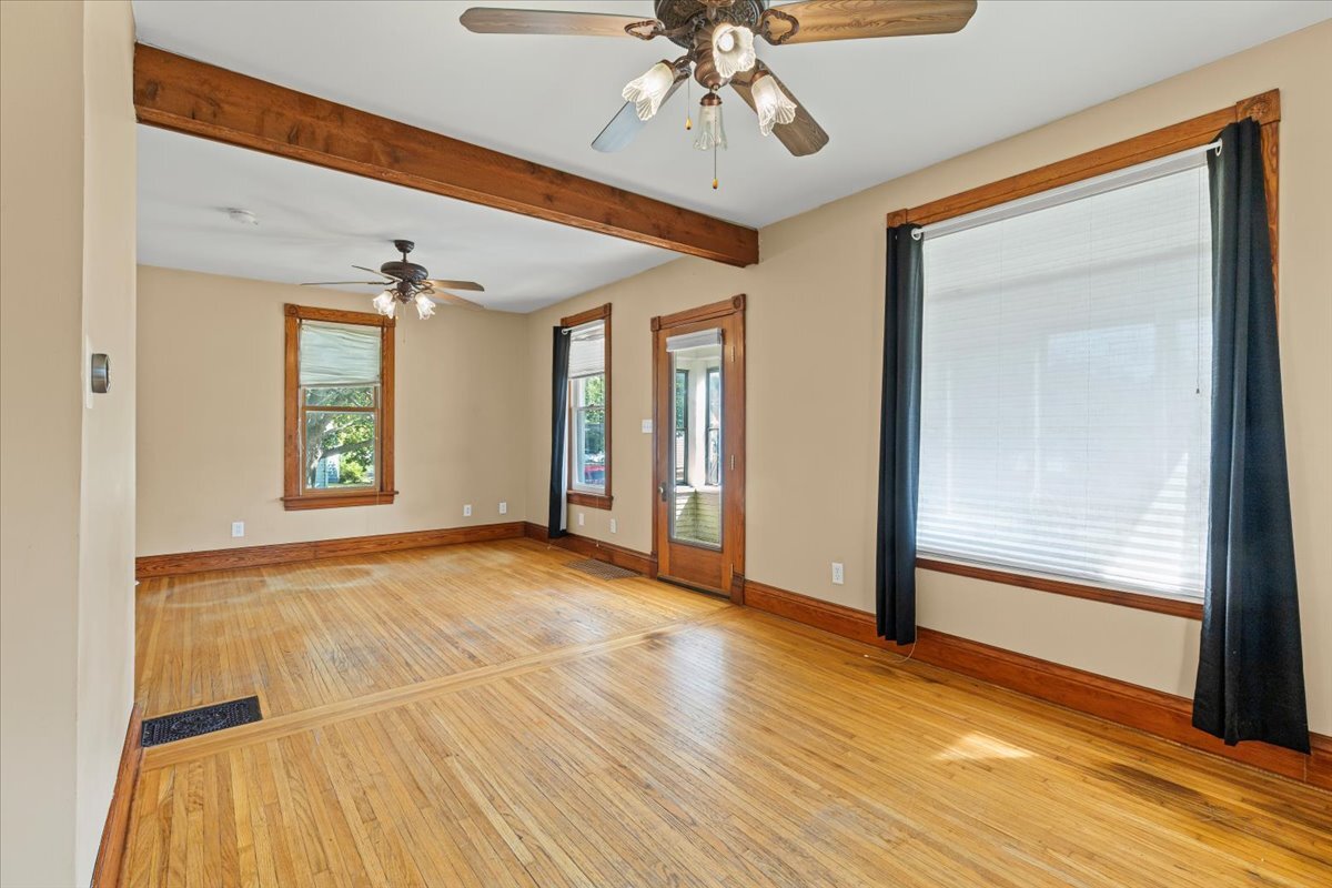 717 Edward Street Sycamore, IL 60178 - Photo 4 of 21 a view of an empty room with wooden floor and a window