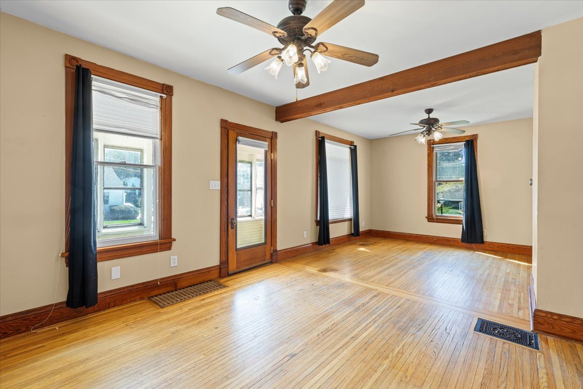 717 Edward Street Sycamore, IL 60178 - Photo 5 of 21 a view of an empty room with window and wooden floor