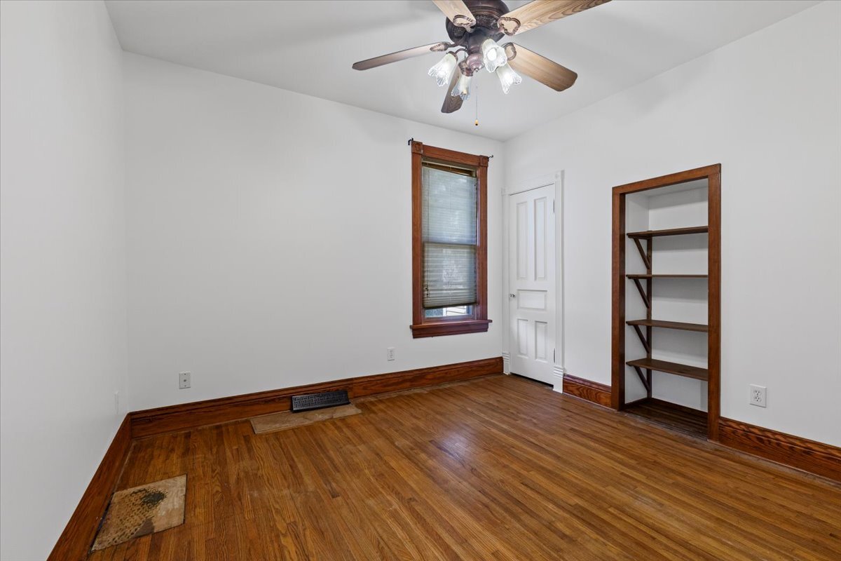 717 Edward Street Sycamore, IL 60178 - Photo 10 of 21 wooden floor in an empty room with a window