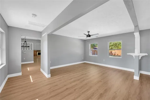 a kitchen with white cabinets and window