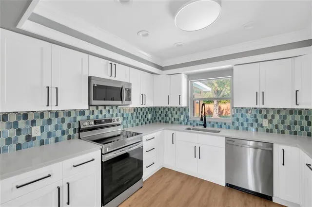 a kitchen with stainless steel appliances a refrigerator and a stove top oven