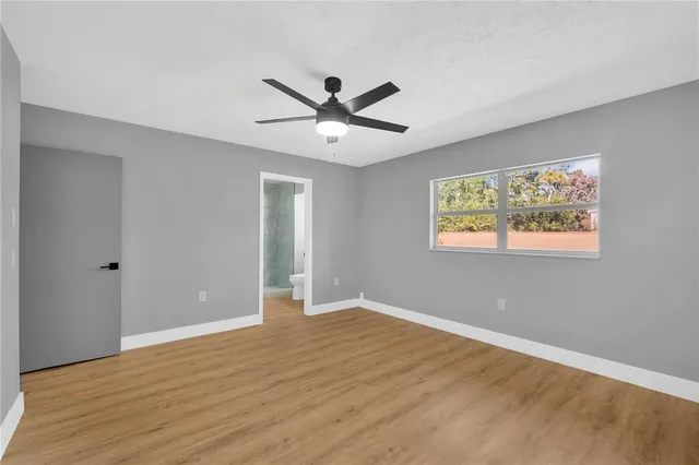 a view of a room with wooden floor and a bathroom