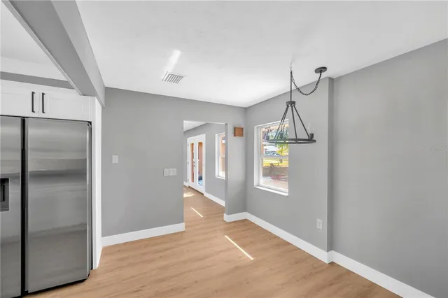 a view of an entryway with wooden floor and a livingroom
