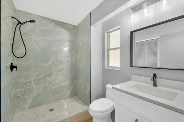 a bathroom with a sink toilet and shower