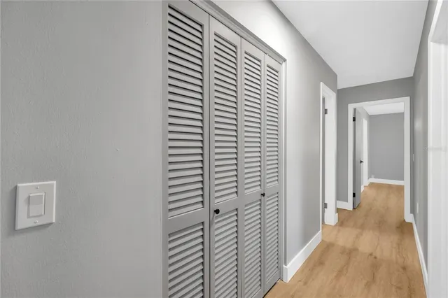 a view of an empty room with glass door and a window