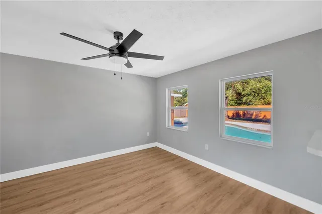 a view of an empty room with a fireplace and a window