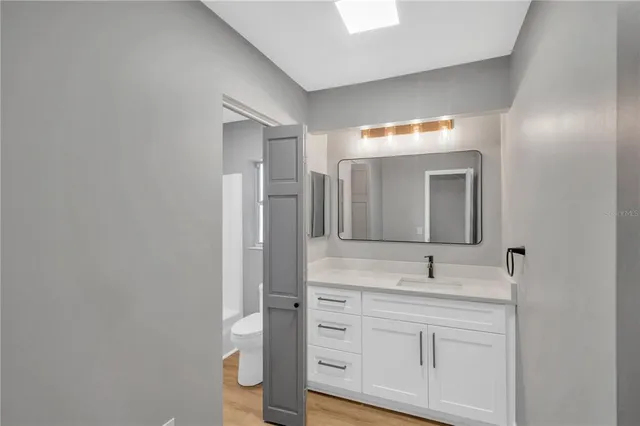 a bathroom with a sink vanity and mirror