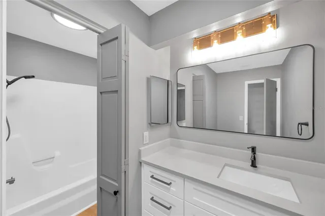 a bathroom with a bathtub and a sink