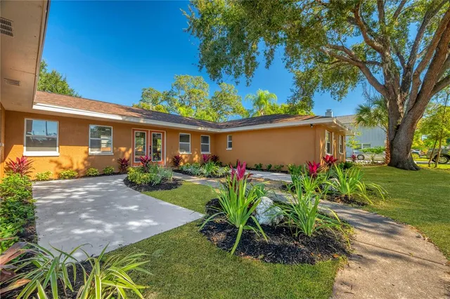a view of a house with a yard and a garden
