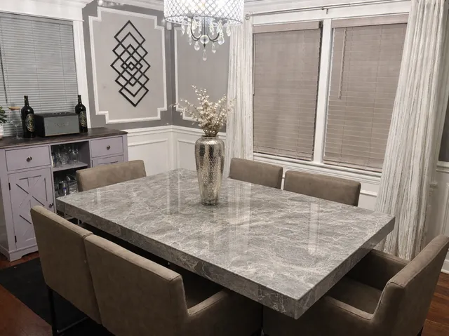 a view of a dining room with a table and chairs