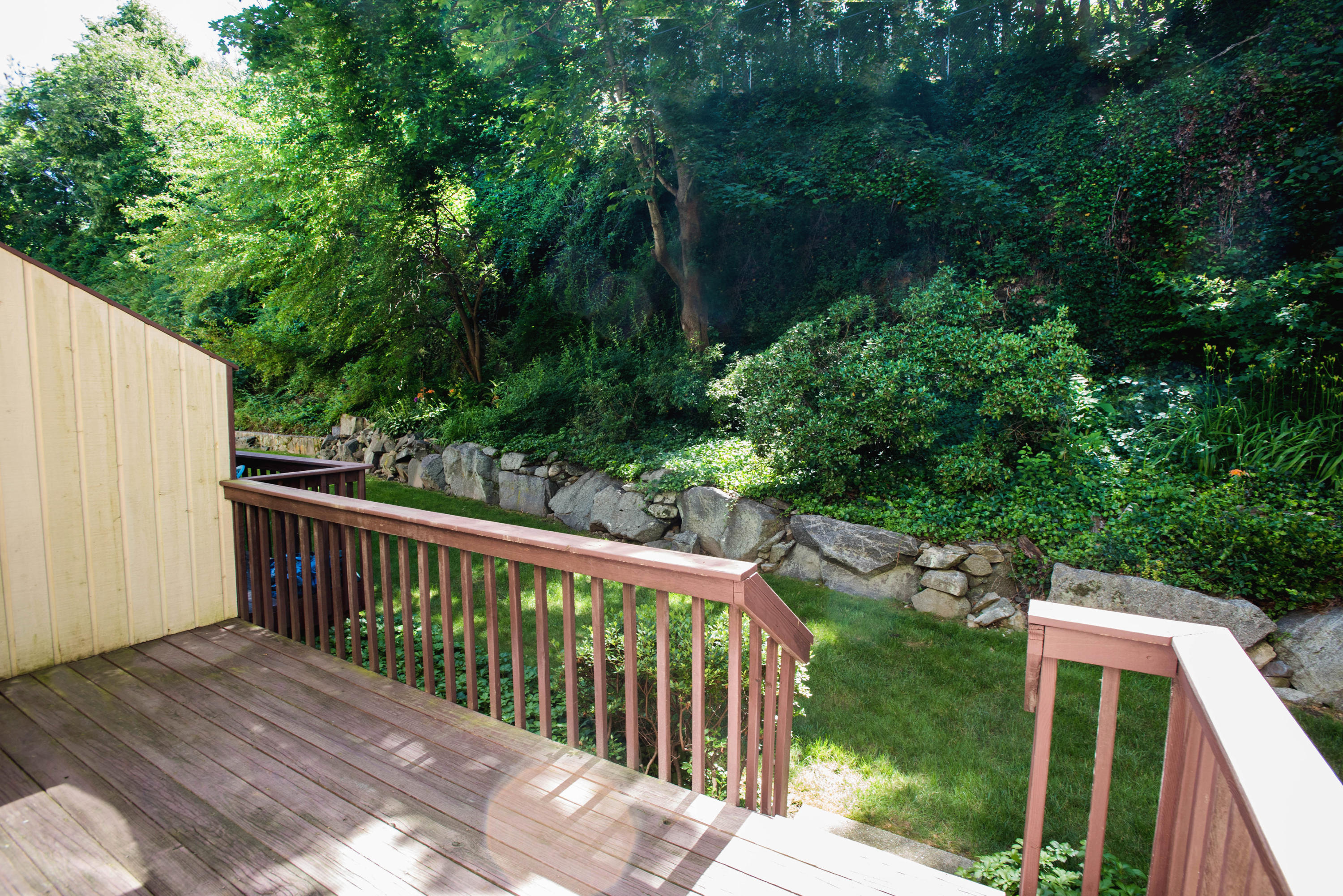 300 Flax Hill Road, Unit 6 Norwalk, CT 06854 - Photo 15 of 18 a view of a wooden deck next to a yard