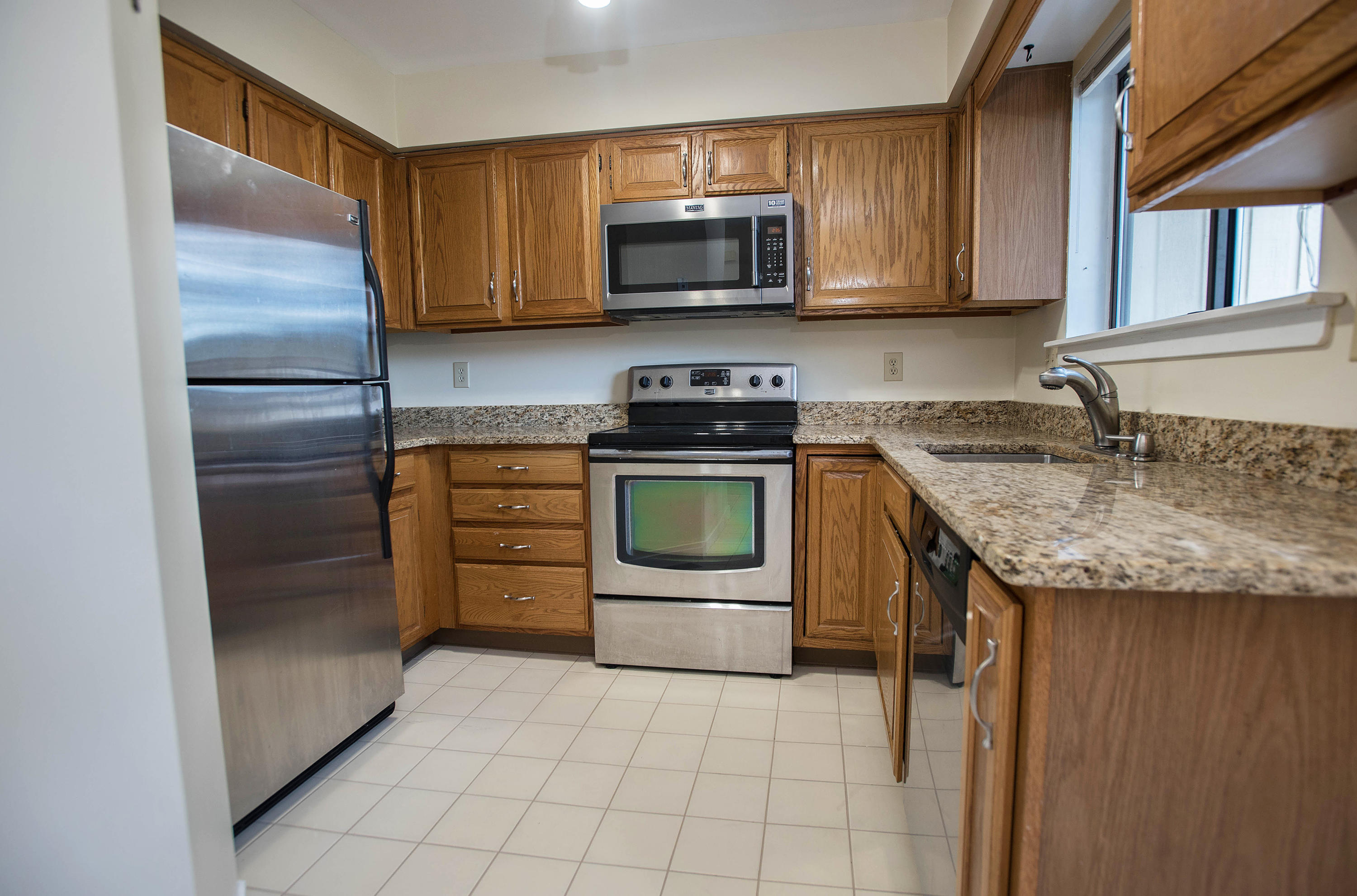 300 Flax Hill Road, Unit 6 Norwalk, CT 06854 - Photo 2 of 18 a kitchen with granite countertop a sink and a stove top oven