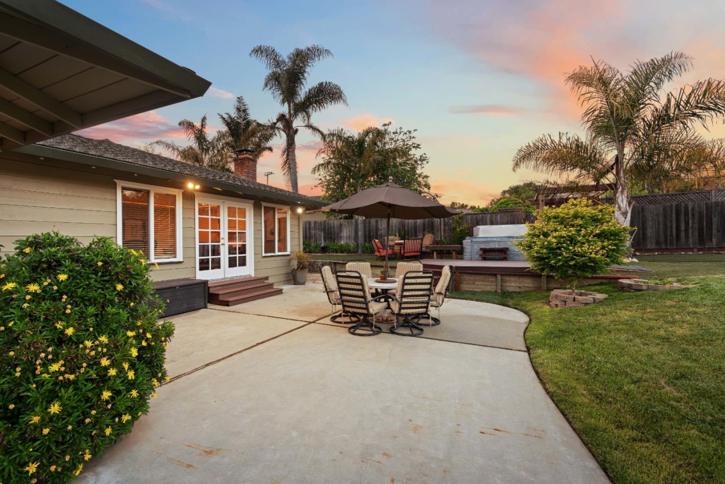 2732 Estates Drive Aptos, CA 95003 - Photo 41 of 63 a view of a patio with table and chairs potted plants and a palm tree