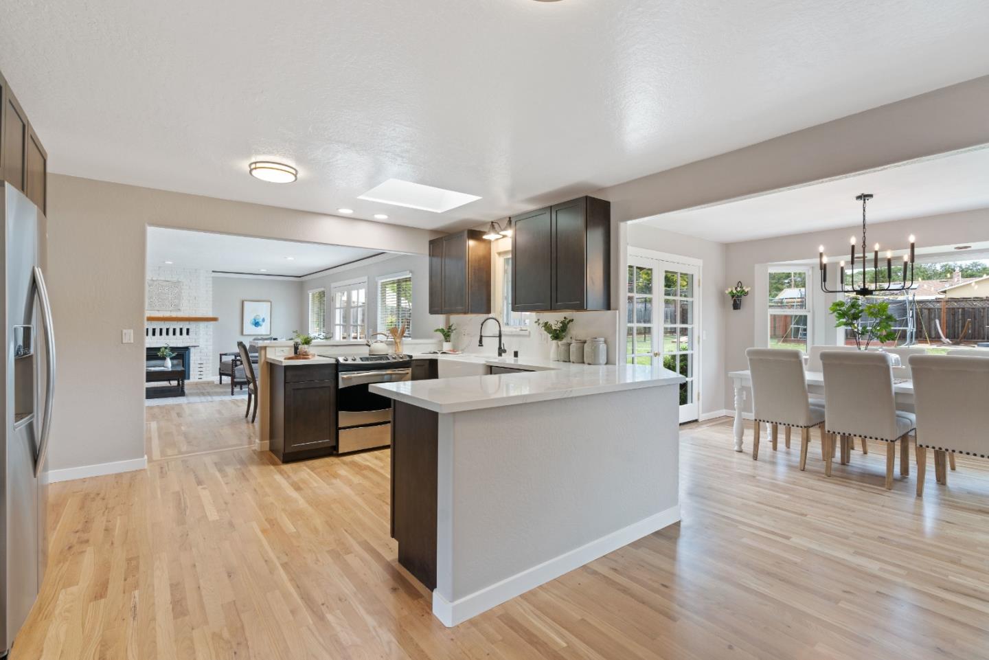 2732 Estates Drive Aptos, CA 95003 - Photo 5 of 63 a living room with stainless steel appliances kitchen island granite countertop wooden floor a dining table and chairs