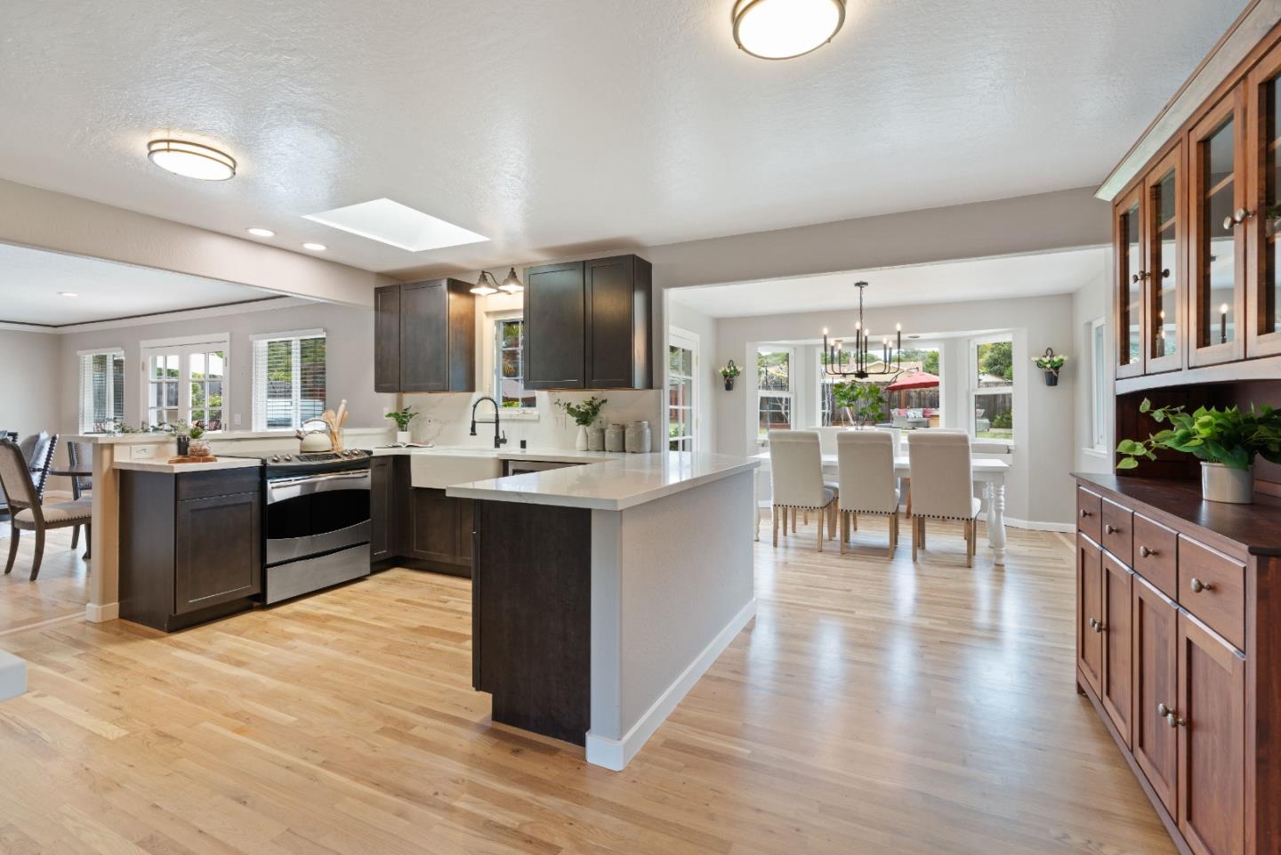 2732 Estates Drive Aptos, CA 95003 - Photo 6 of 63 a kitchen with stainless steel appliances kitchen island granite countertop a stove top oven a sink a dining table and chairs