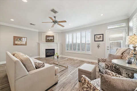 a living room with furniture and a wooden floor
