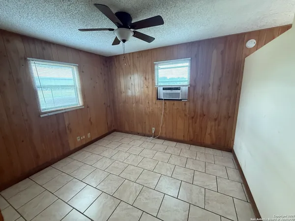 a view of an empty room and a window