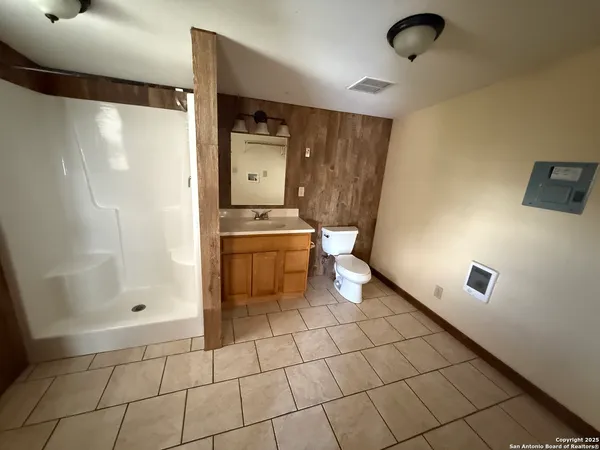a bathroom with a shower and a toilet