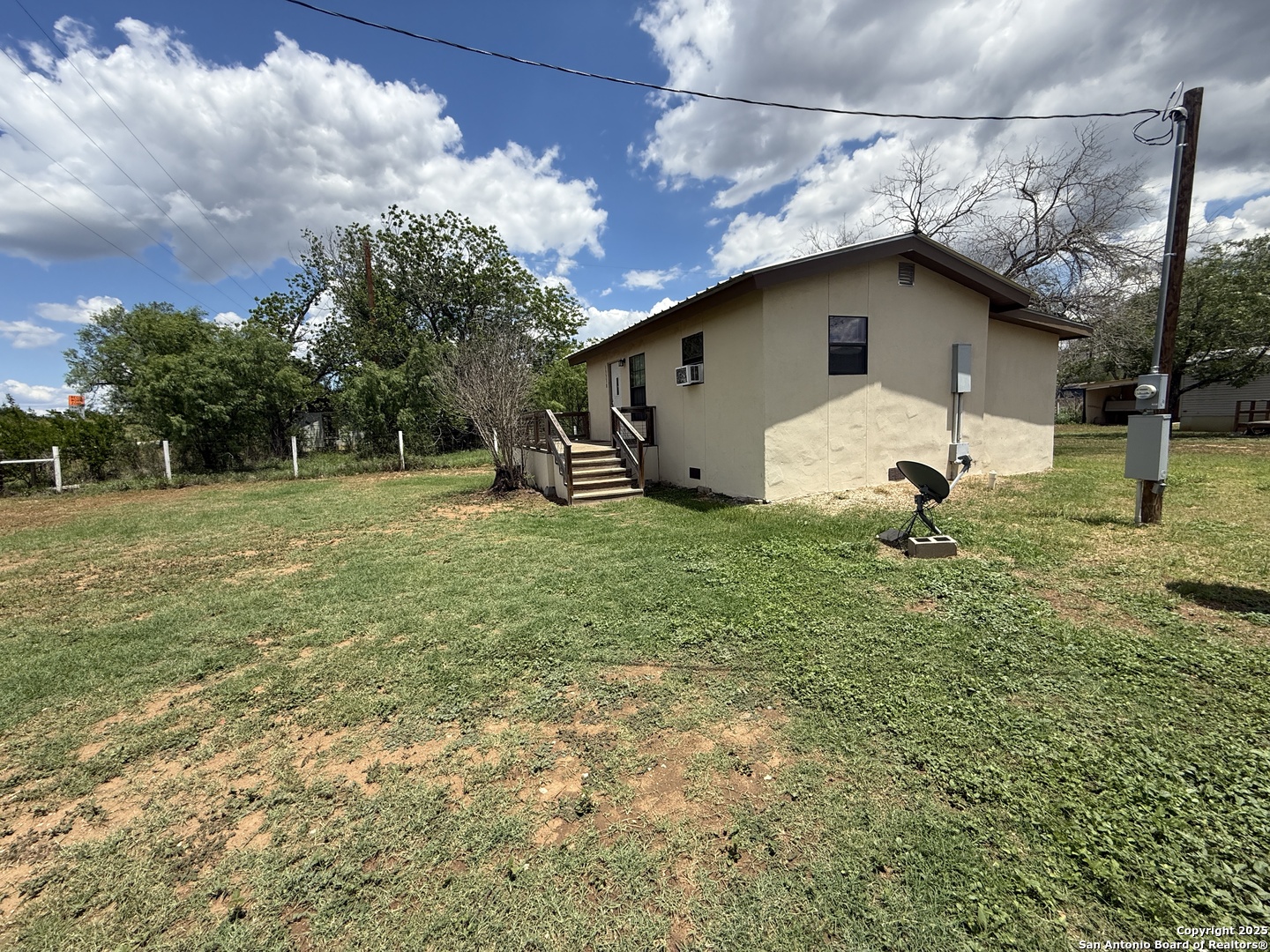 13338 Interstate 35 Moore, TX 78057 - Photo 25 of 37 a house with lots of trees in the background