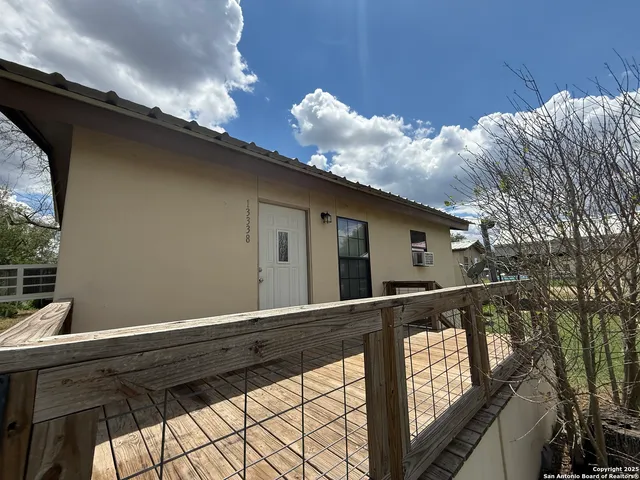 a view of house with backyard and trees
