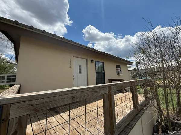 a view of house with backyard and trees