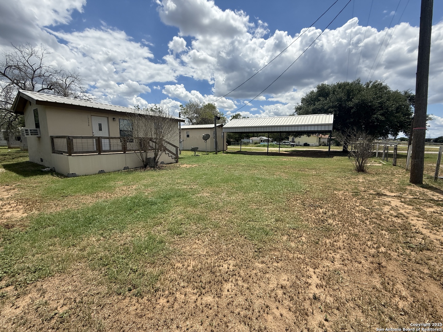 13338 Interstate 35 Moore, TX 78057 - Photo 30 of 37 a view of a backyard with potted plants and a large tree