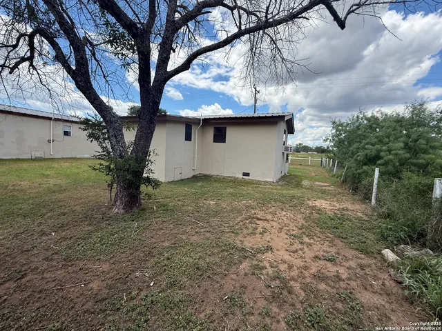 a view of a backyard with large trees