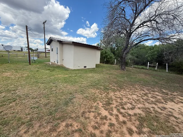 a view of a backyard with large trees