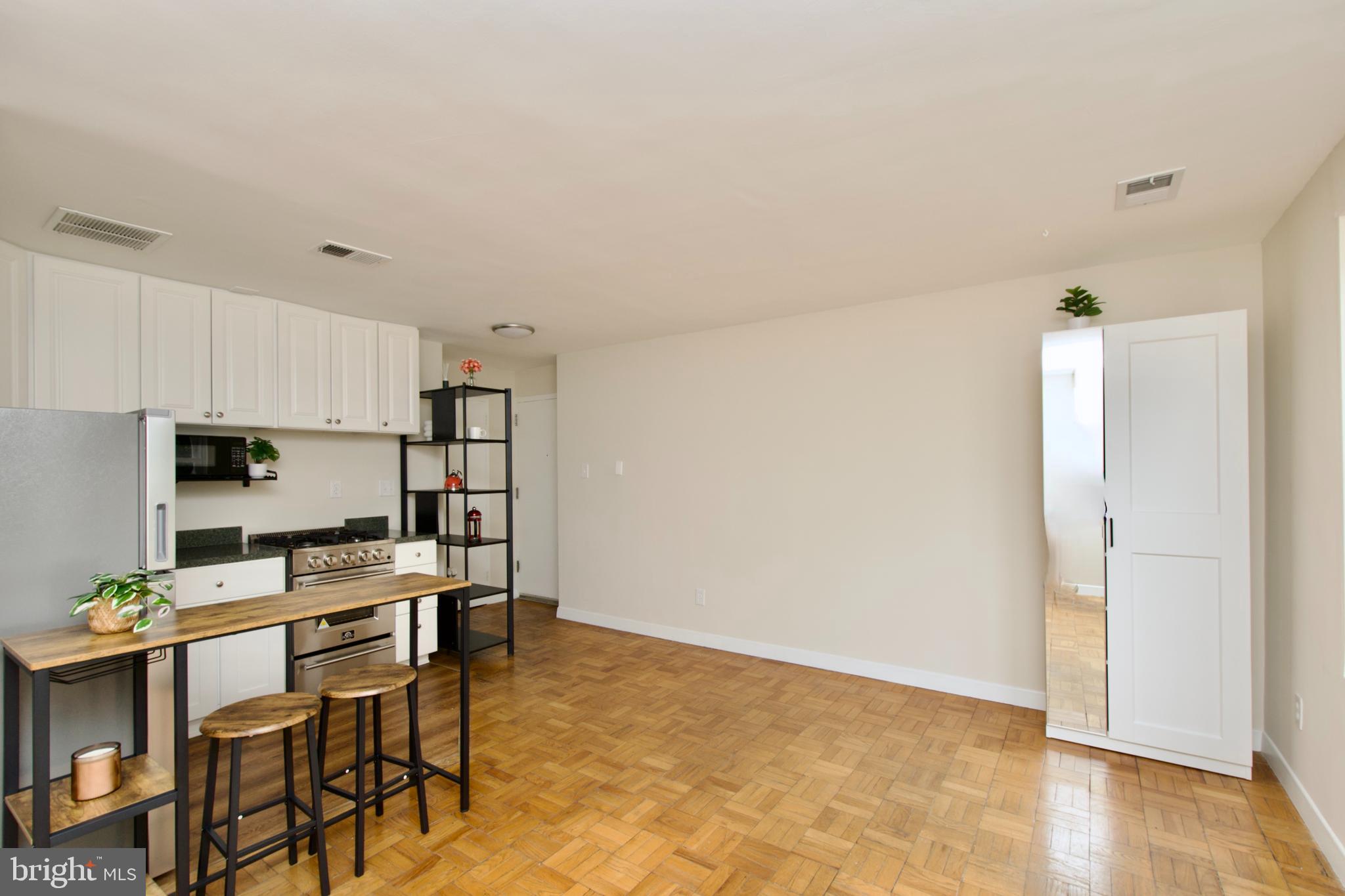 4840 MacArthur Boulevard Northwest, Unit 54 Washington, DC 20007 - Photo 14 of 28 a kitchen with stainless steel appliances a refrigerator and a stove top oven