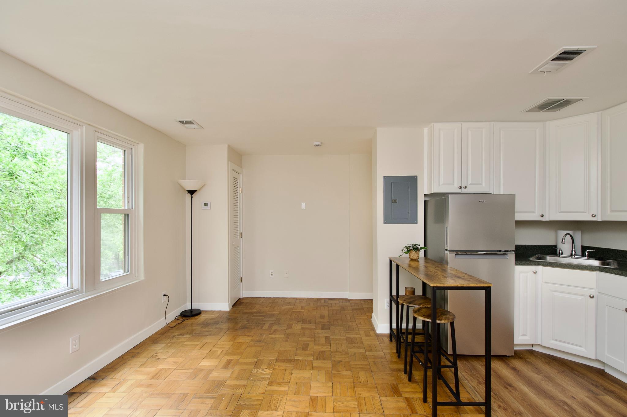 4840 MacArthur Boulevard Northwest, Unit 54 Washington, DC 20007 - Photo 19 of 28 a view of kitchen with wooden floor and electronic appliances