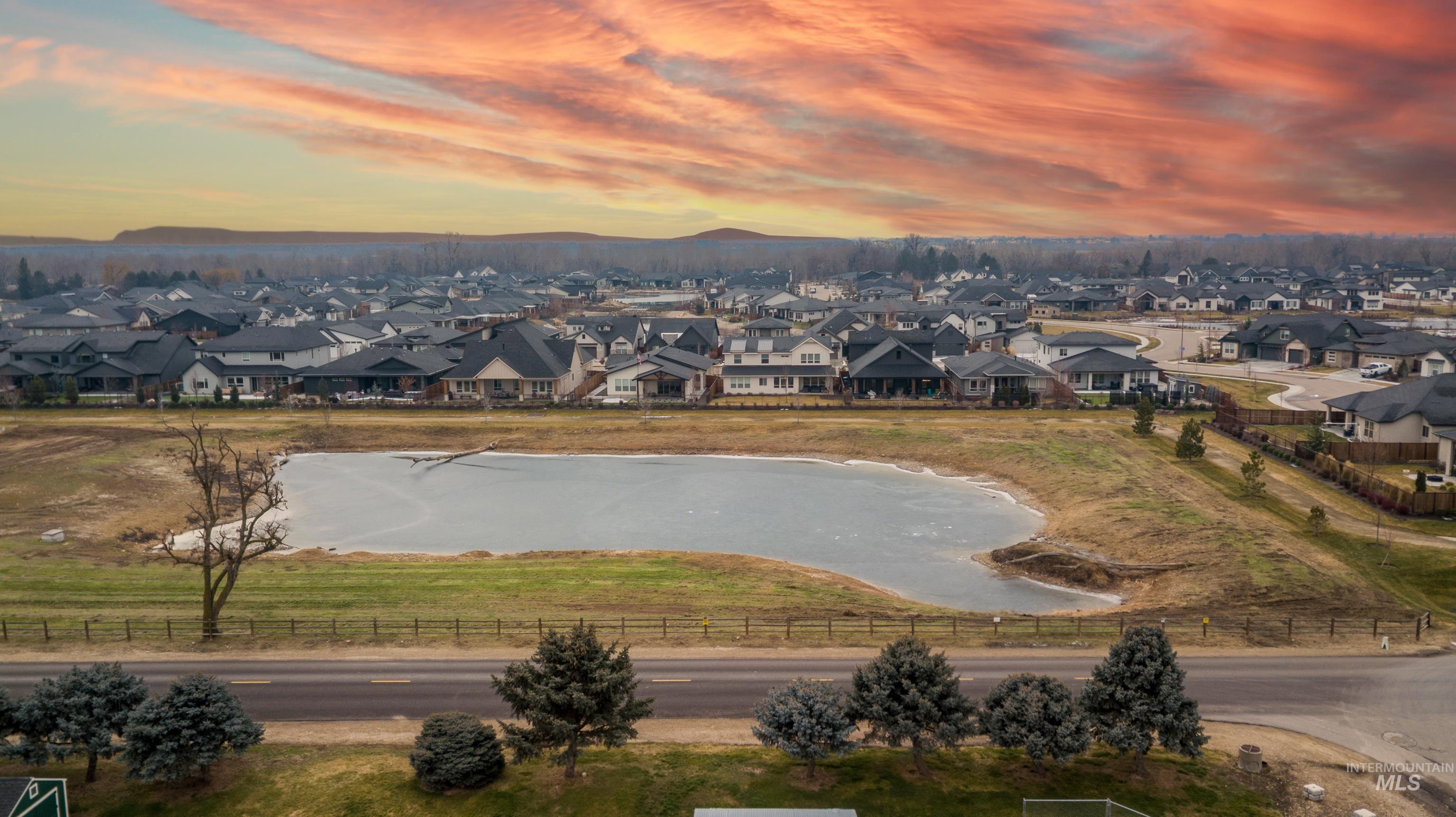 7595 West Moon Valley Road Eagle, ID 83616 - Photo 7 of 18 Aerial view at dusk of a residential view and a mountain view
