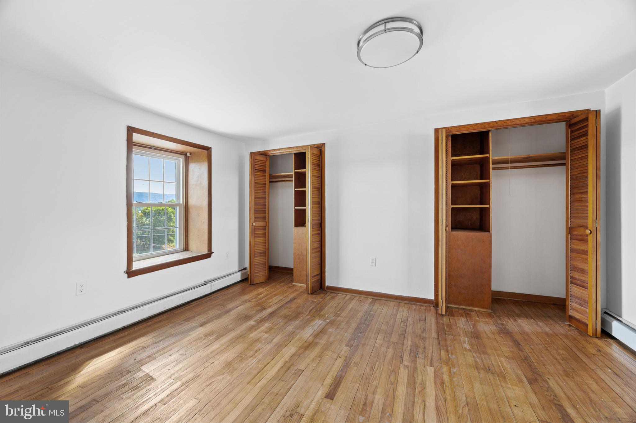 4071 Kabletown Road Charles Town, WV 25414 - Photo 11 of 29 an empty room with wooden floor and windows