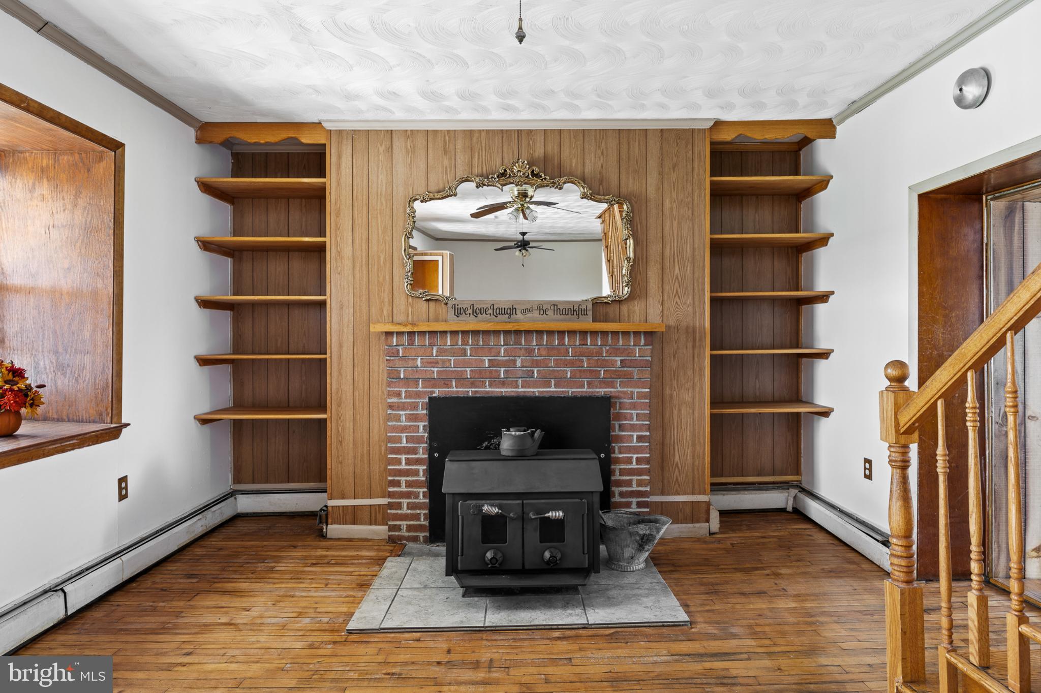 4071 Kabletown Road Charles Town, WV 25414 - Photo 8 of 29 a living room with a fireplace and a wooden floor
