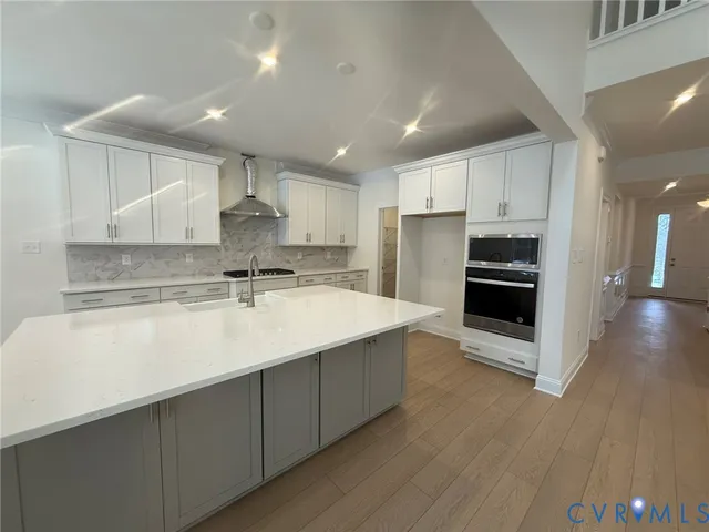a kitchen with a sink stainless steel appliances and cabinets