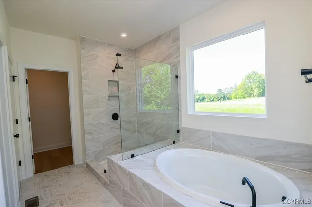 a bathroom with a tub and a shower