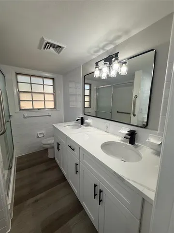 a bathroom with a double vanity sink and a mirror