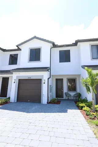 a view of a house with a yard and garage