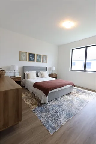 a bedroom with a large bed and a window