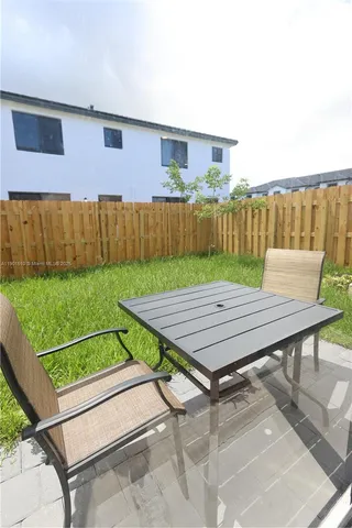 a view of a roof deck with wooden floor and fence