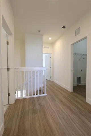 a view of wooden floor and windows in a room