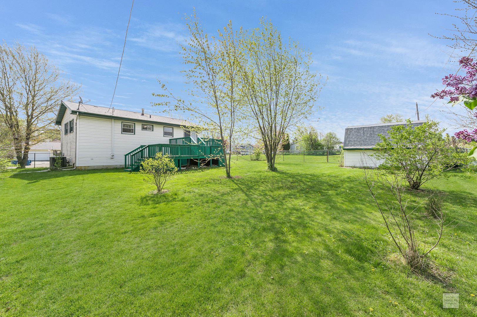 1860 Nottingham Drive Aurora, IL 60505 - Photo 21 of 22 a backyard of a house with table and chairs plants and large tree