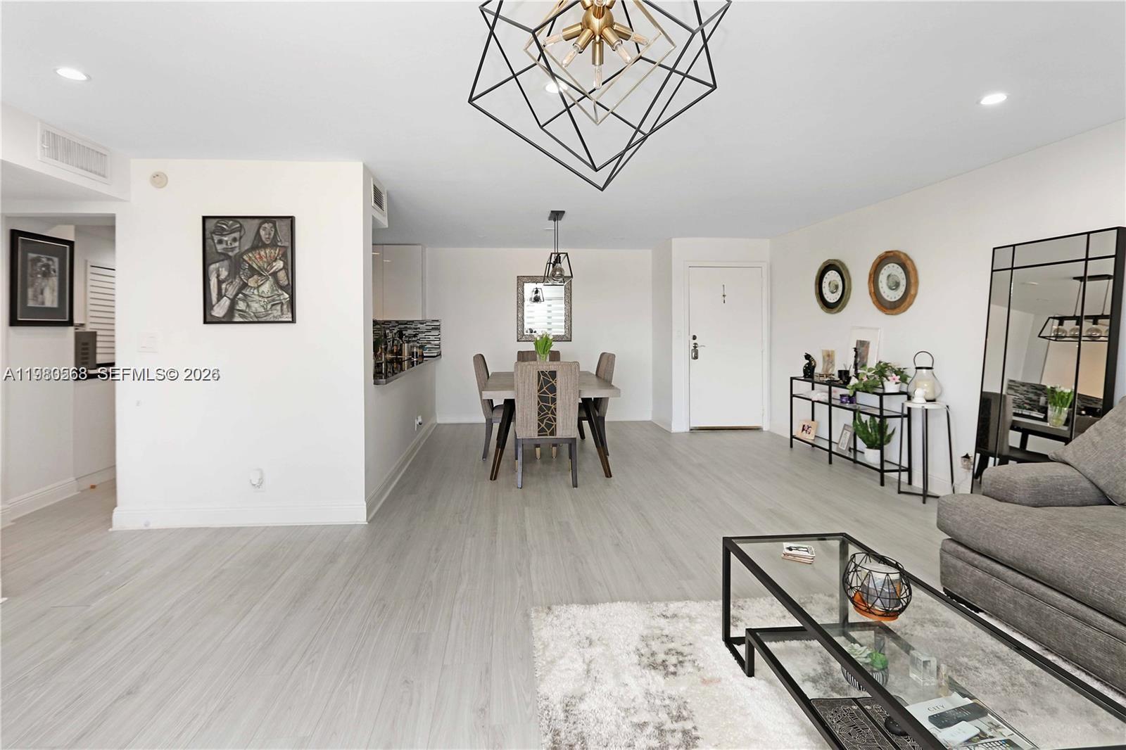 14203 Southwest 66th Street, Unit 503 Miami, FL 33183 - Photo 3 of 19 a living room with furniture and wooden floor