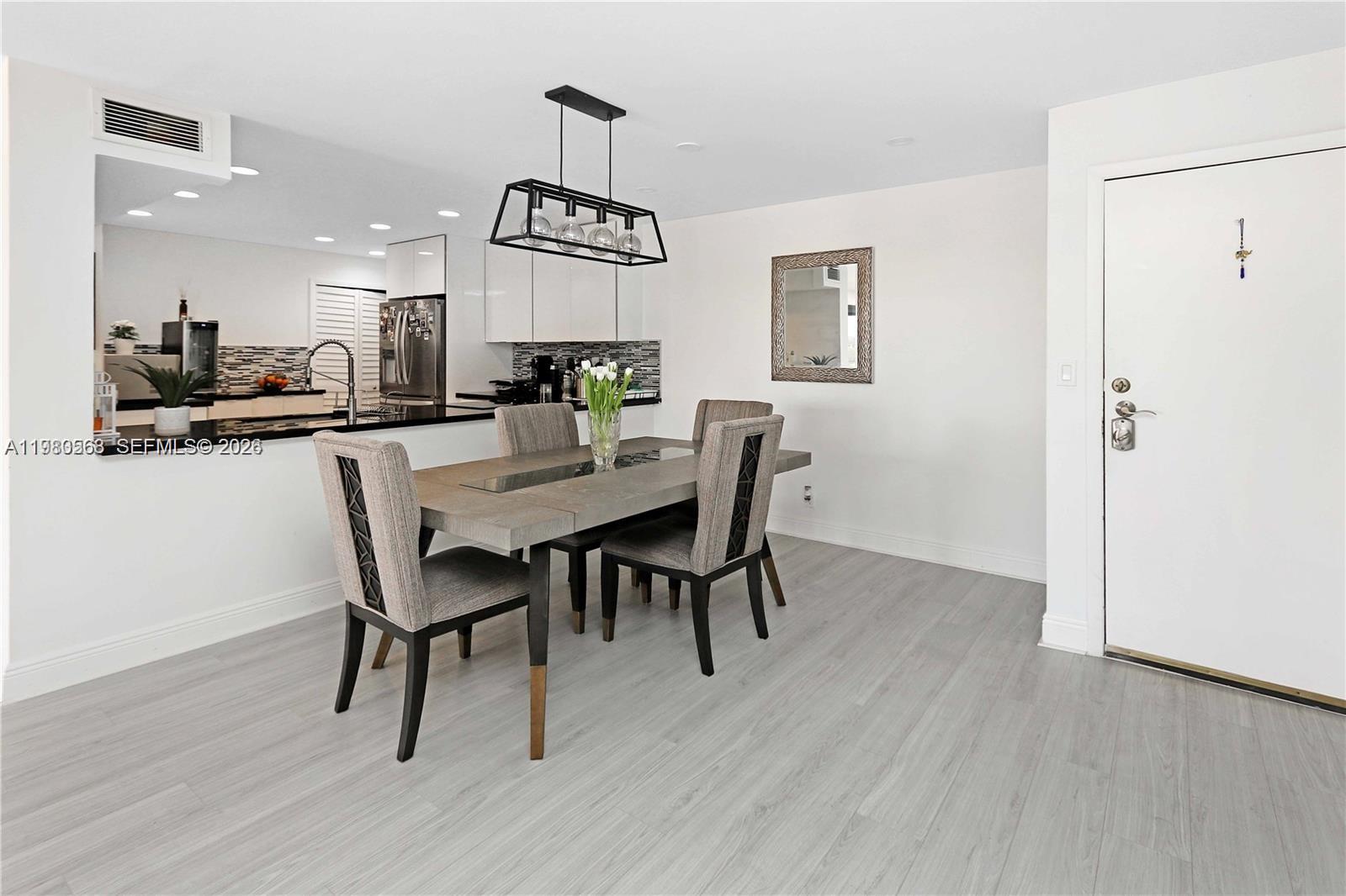 14203 Southwest 66th Street, Unit 503 Miami, FL 33183 - Photo 4 of 19 a view of a dining room with furniture and wooden floor