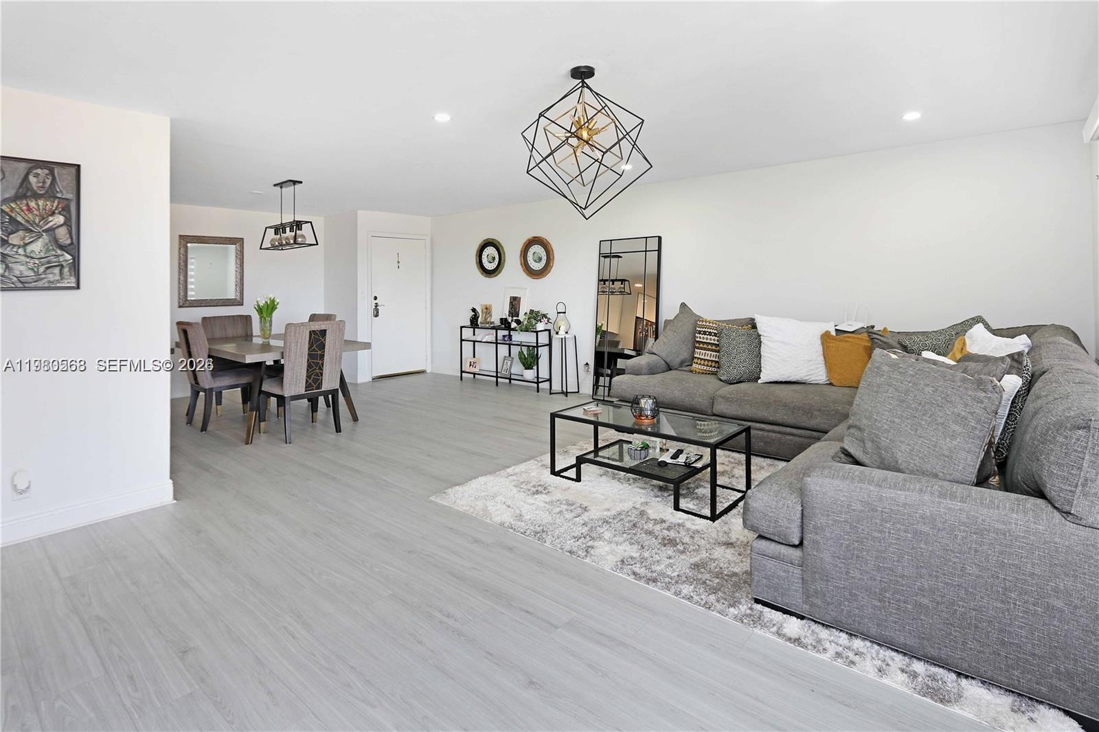 14203 Southwest 66th Street, Unit 503 Miami, FL 33183 - Photo 7 of 19 a living room with furniture and a wooden floor