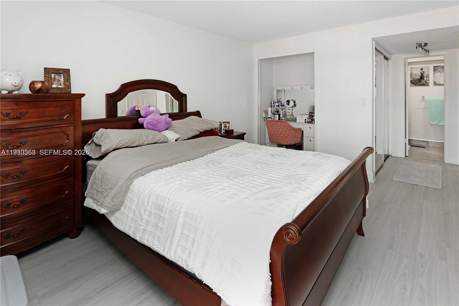 14203 Southwest 66th Street, Unit 503 Miami, FL 33183 - Photo 9 of 19 a bedroom with a bed and a dresser