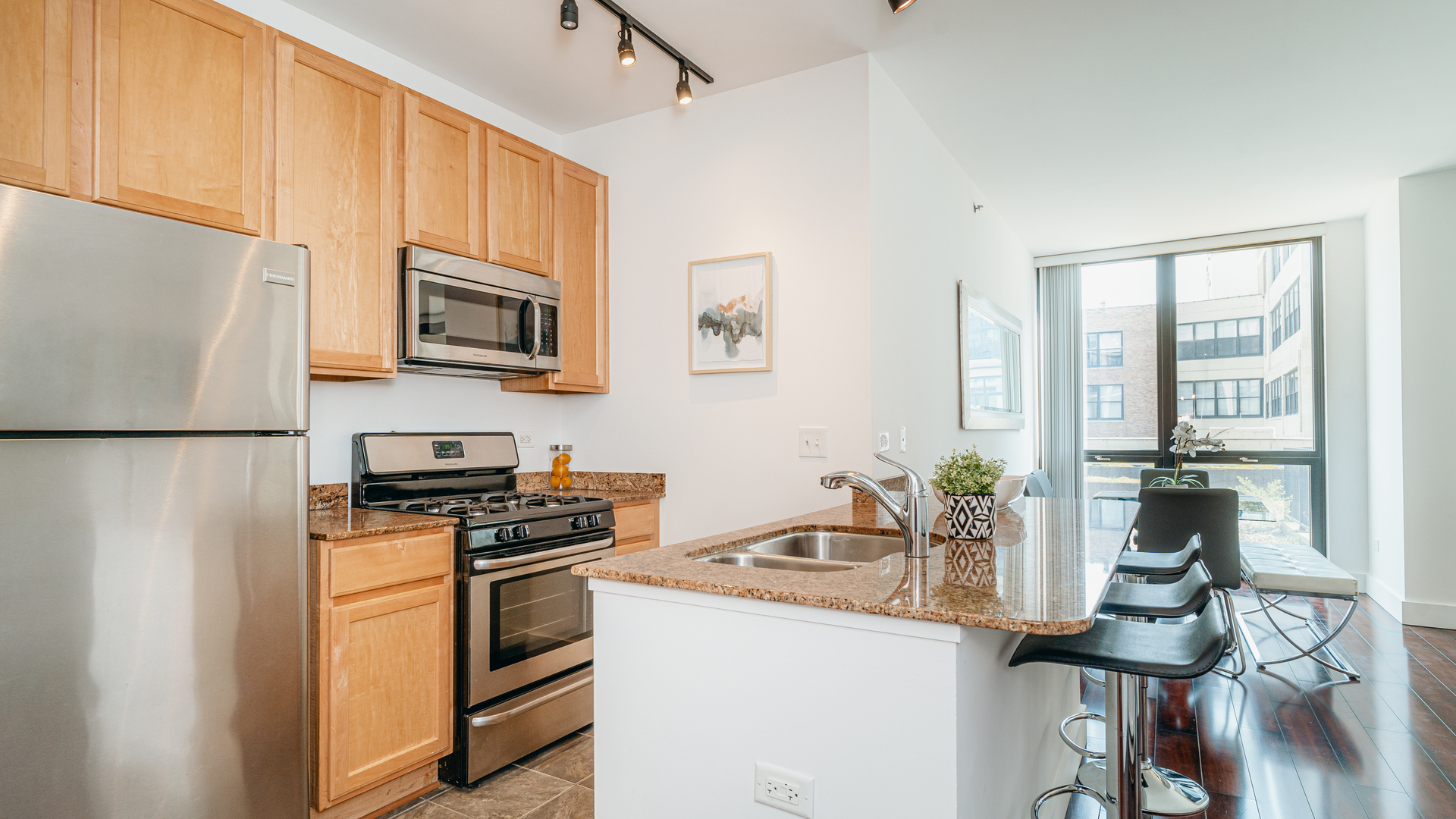 210 South Desplaines Street, Unit 606 Chicago, IL 60661 - Photo 13 of 33 a kitchen with stainless steel appliances a stove a sink and a refrigerator