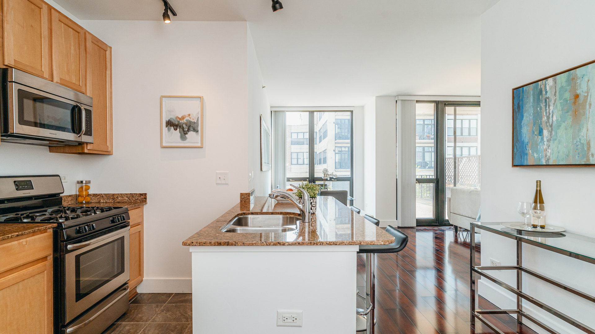 210 South Desplaines Street, Unit 606 Chicago, IL 60661 - Photo 14 of 33 a kitchen with stainless steel appliances a sink stove and microwave