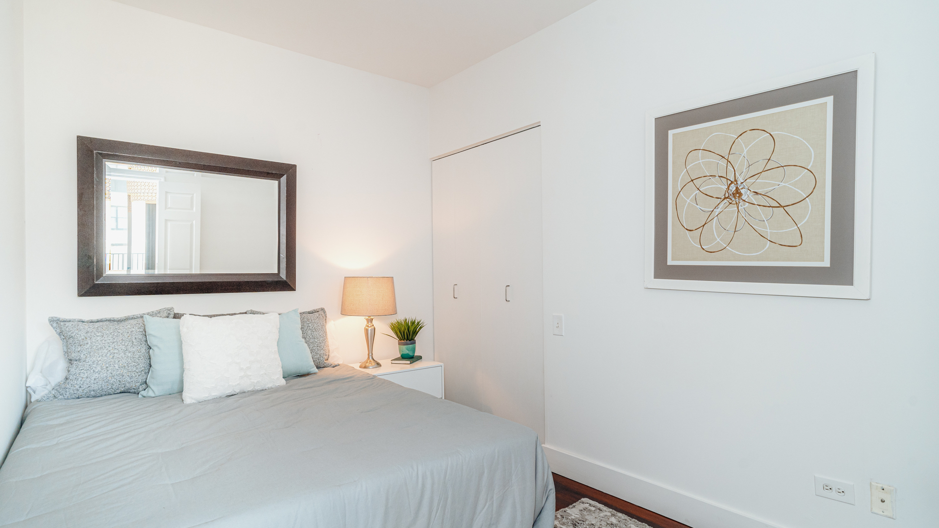 210 South Desplaines Street, Unit 606 Chicago, IL 60661 - Photo 15 of 33 a bedroom with a bed and wall painting