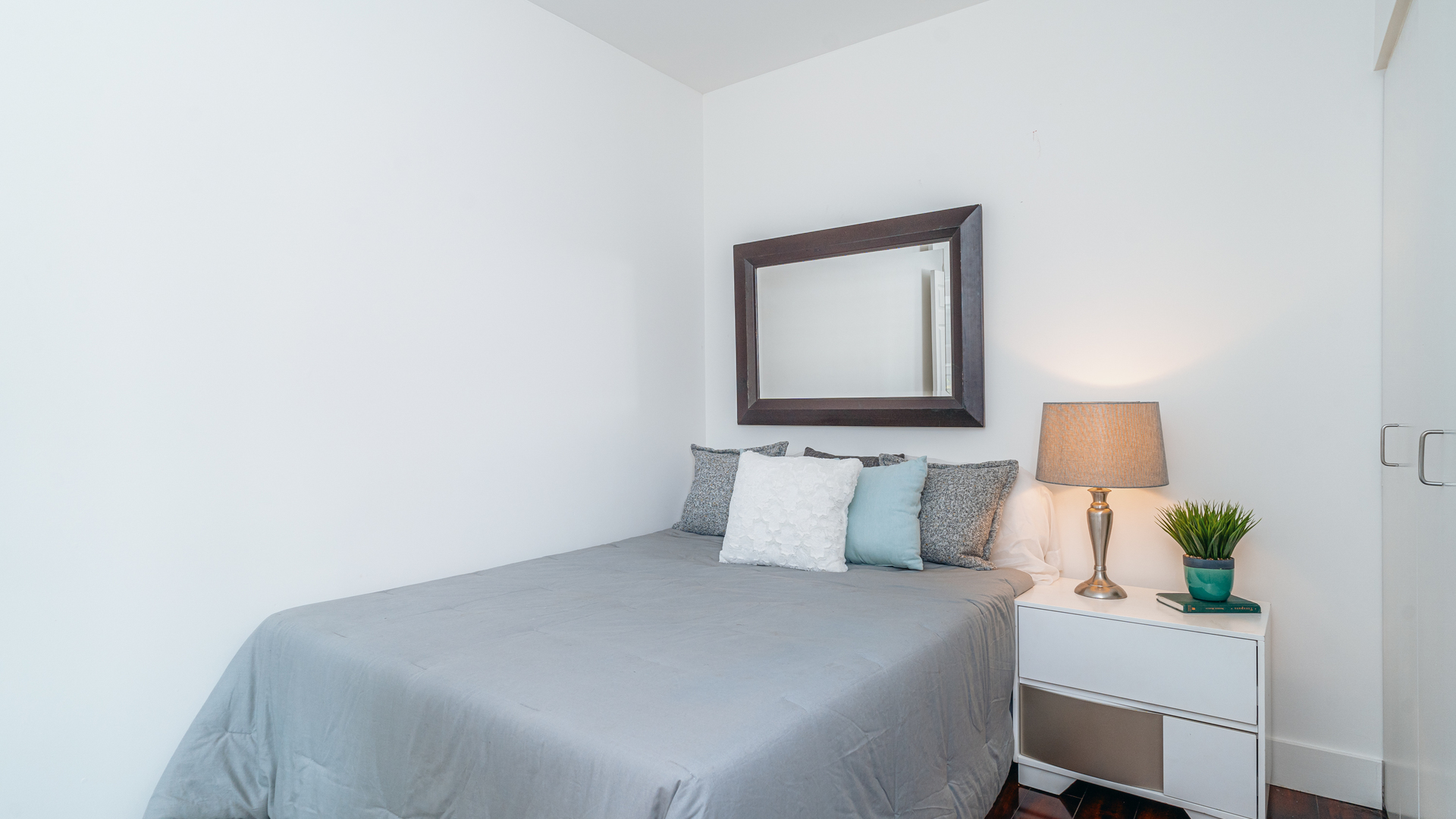 210 South Desplaines Street, Unit 606 Chicago, IL 60661 - Photo 18 of 33 a bedroom with a bed and a lamp on dresser