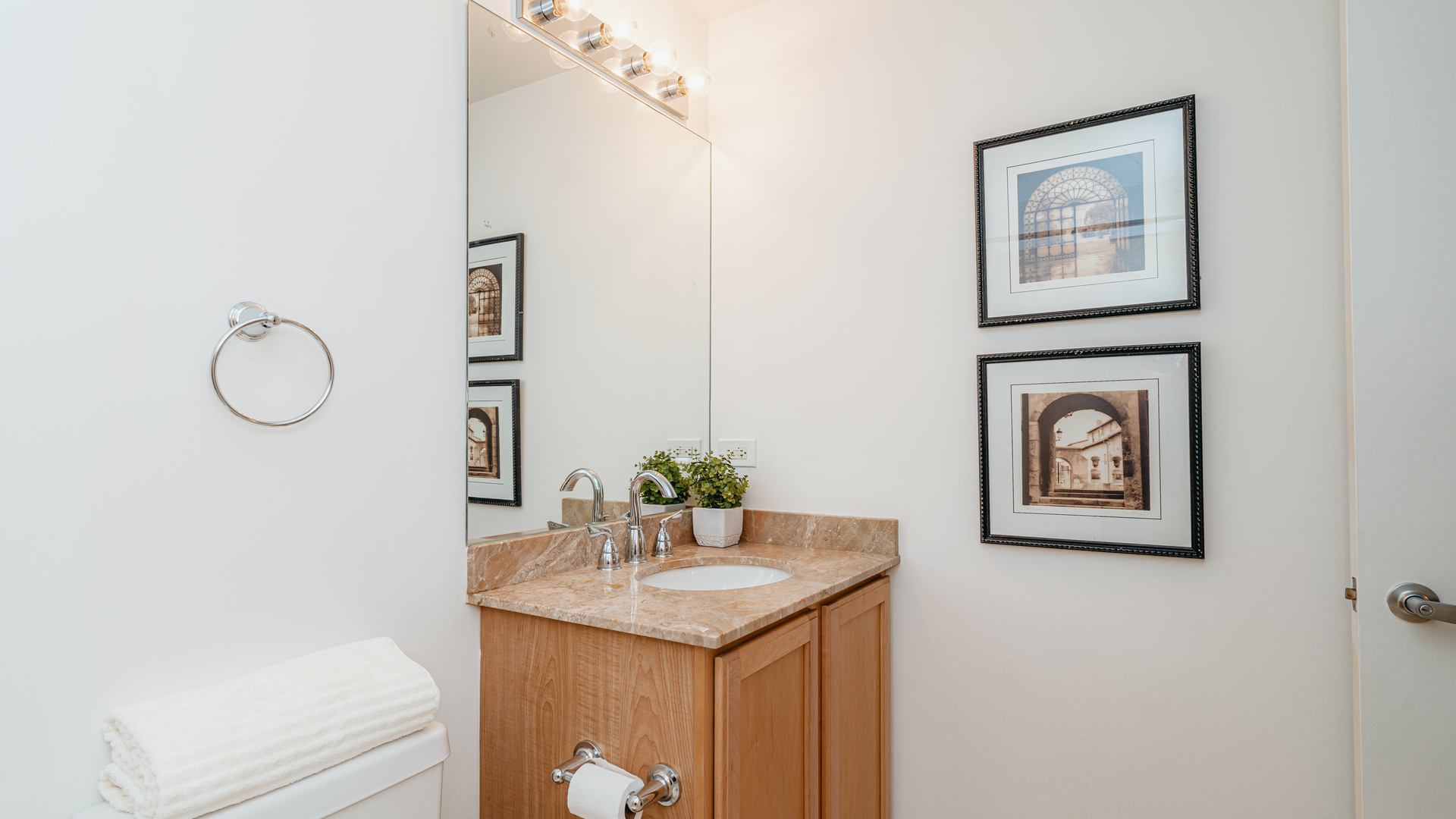 210 South Desplaines Street, Unit 606 Chicago, IL 60661 - Photo 20 of 33 a bathroom with a sink and a mirror